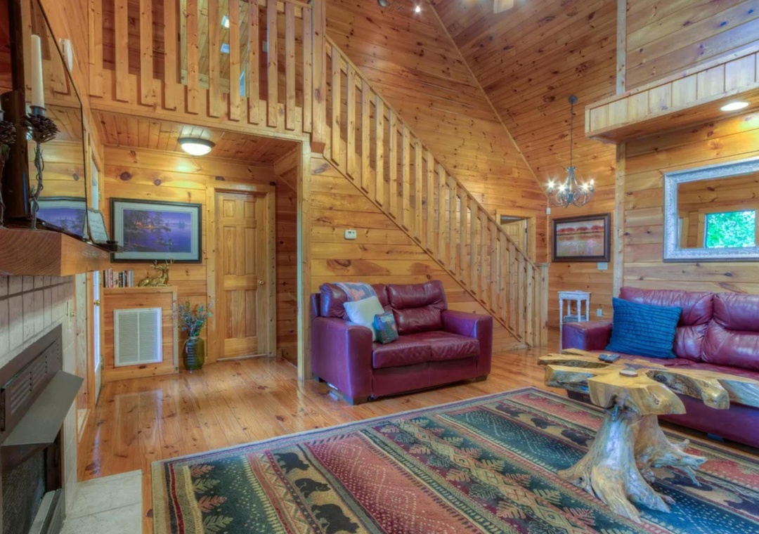 Step into your cozy mountain retreat with warm wood beams, plush leather seating, and a crackling fireplace waiting to welcome you after a day of adventure.
