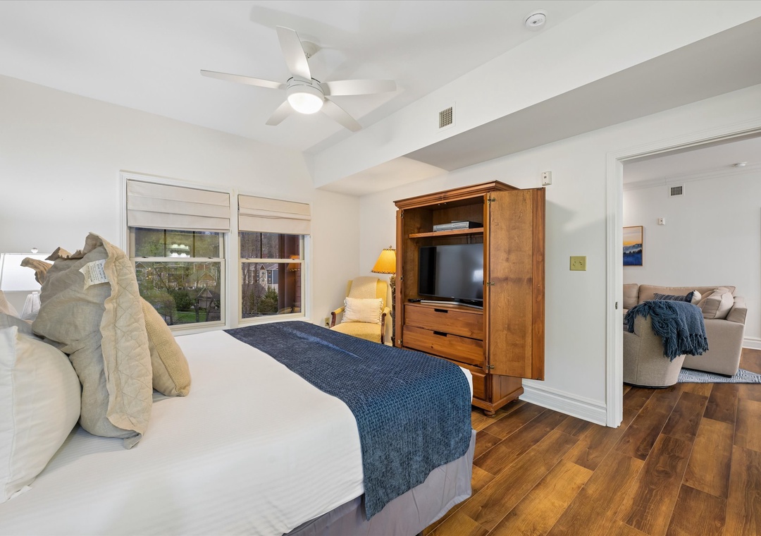 Unwind in your peaceful bedroom with crisp linens, warm wood floors, and your own entertainment center for cozy evenings.