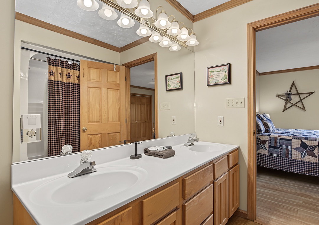 Freshen up in your private ensuite with dual sinks, warm lighting, and direct access to your cozy bedroom just steps away.
