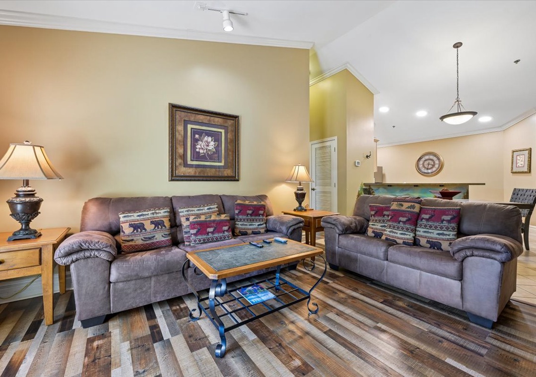 Sink into plush leather sofas with rustic charm pillows in your spacious living room, perfect for unwinding after mountain adventures.
