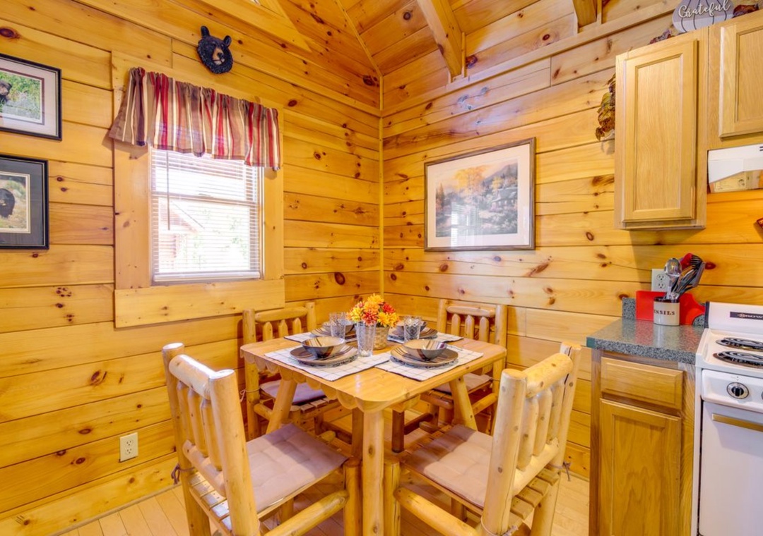 Savor meals in your cozy log cabin dining nook, where rustic charm meets comfort with handcrafted wooden furniture and mountain views.