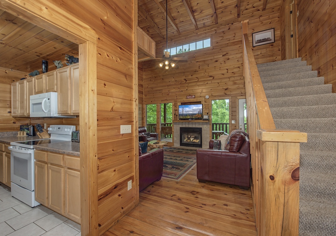 Step inside your cozy mountain retreat, where warm wood surrounds you at every turn. Relax on plush leather sofas by the fireplace, cook in the well-equipped kitchen, and feel the cabin charm wrap around you.