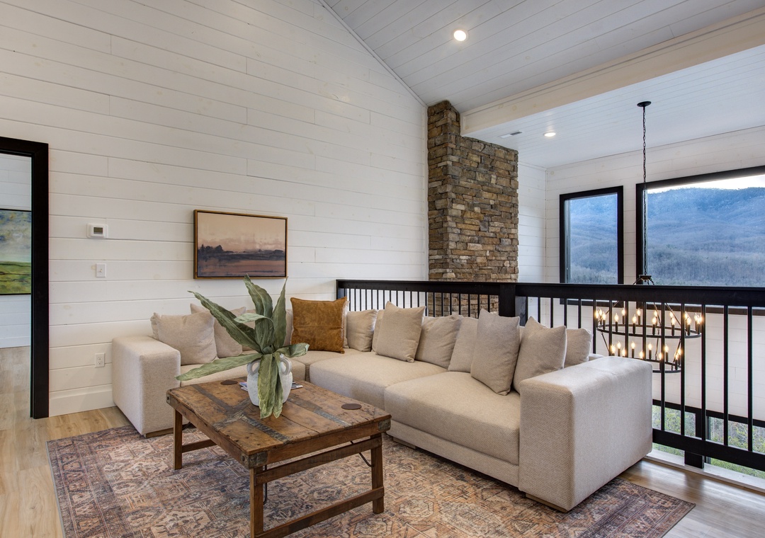 Unwind in your cozy loft lounge, where plush seating and rustic charm create the perfect spot to relax after exploring.