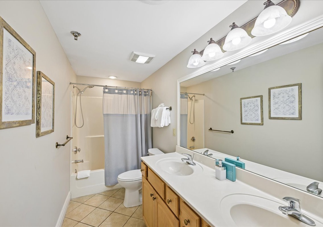 Your spacious bathroom features dual vanities and a relaxing tub-shower combo, perfect for refreshing after your adventures.