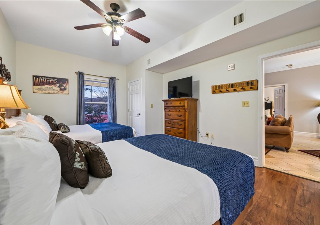You'll love unwinding in this cozy bedroom with twin beds, warm wood furnishings, and rustic mountain charm.