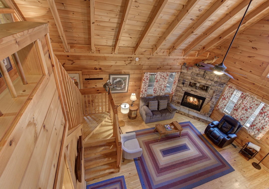 Step into rustic charm with exposed beam ceilings, stone fireplace, and cozy seating perfect for your mountain getaway.