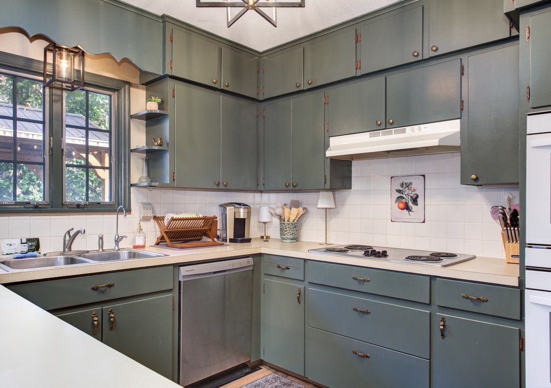 Your fully equipped kitchen features sage-green cabinets, modern appliances, and everything you need to create memorable meals during your stay.