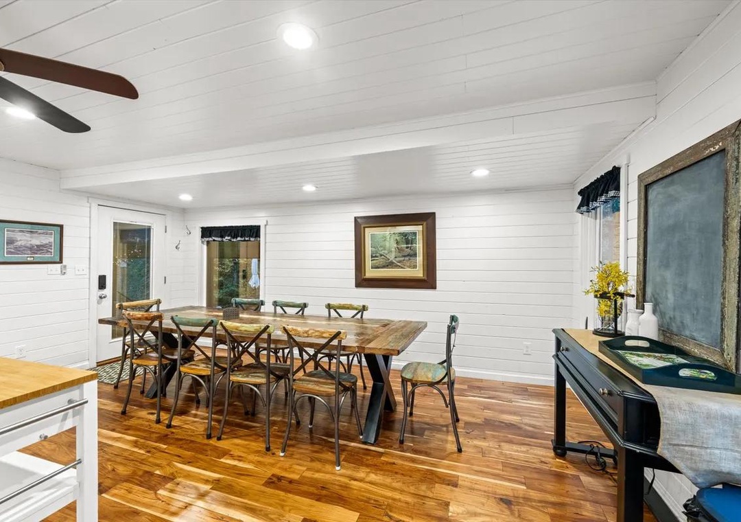 Gather around the handcrafted wood table under the charm of vaulted shiplap ceilings. The warm hardwood floors and cozy farmhouse touches create the perfect spot for your group's meals and conversations.