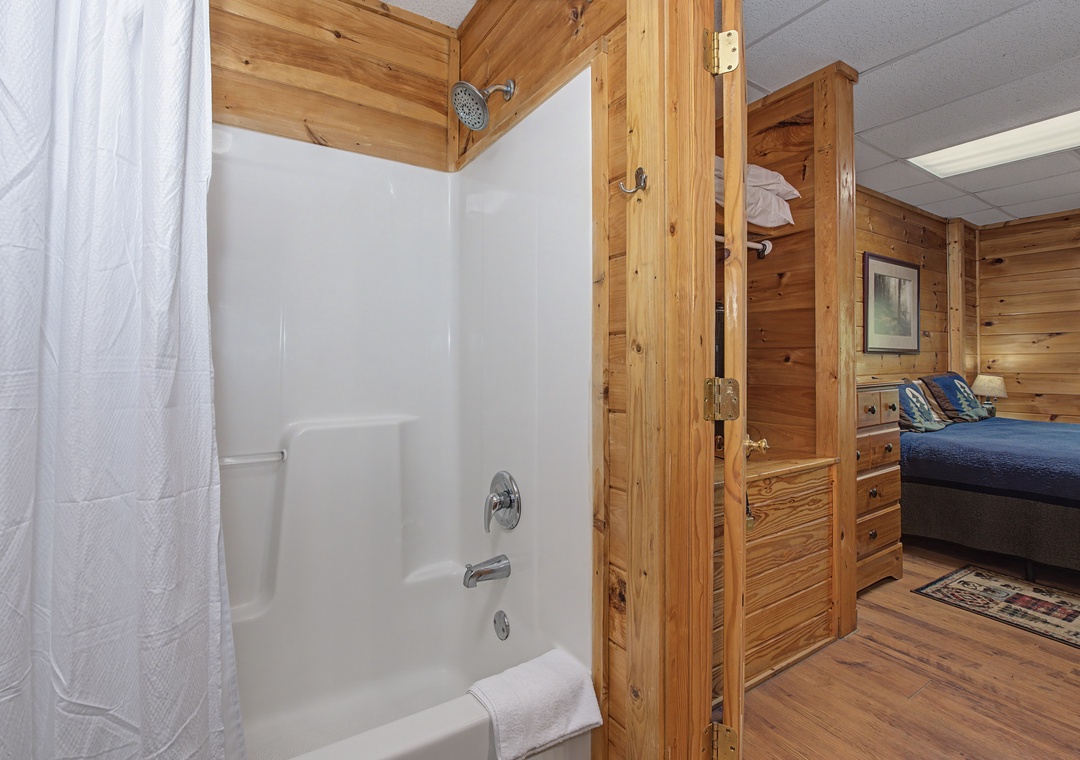 Your rustic cabin bathroom features warm wood accents and a relaxing tub-shower combo for unwinding after mountain adventures.