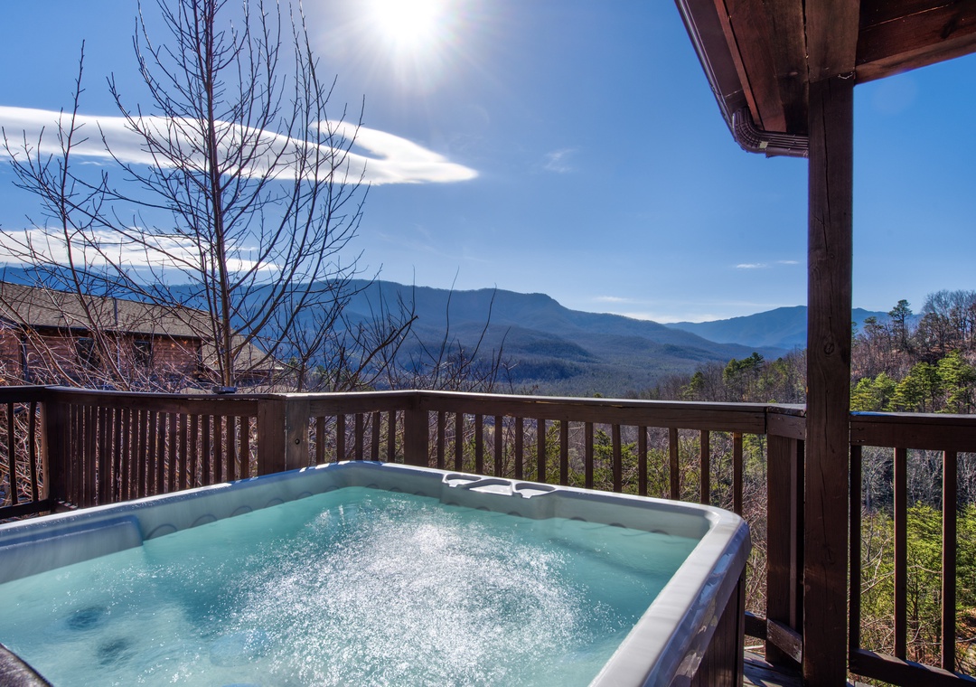 Soak in your private hot tub while drinking in breathtaking mountain vistas that stretch endlessly before you.