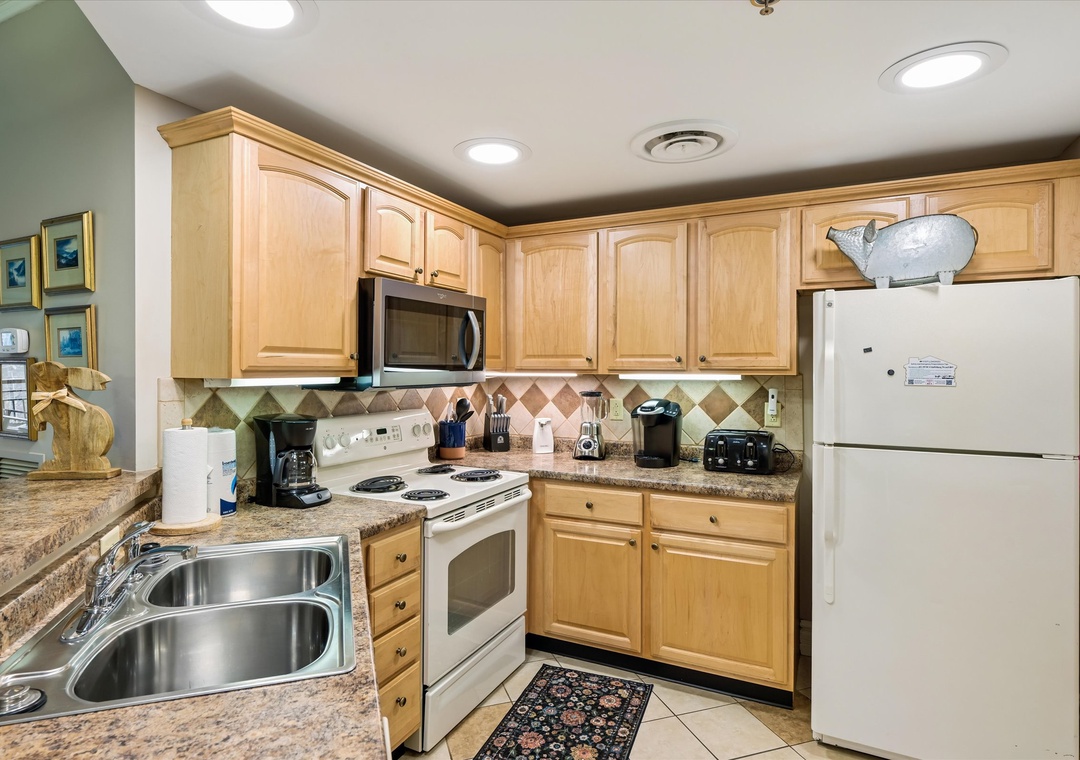 Your fully equipped kitchen features everything you need to prepare meals, from granite countertops to full appliances and charming tile backsplash.