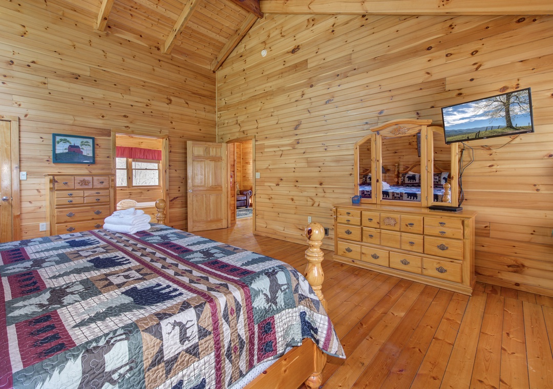 Your rustic bedroom surrounds you in warm cedar with handcrafted furniture and a cozy quilt.