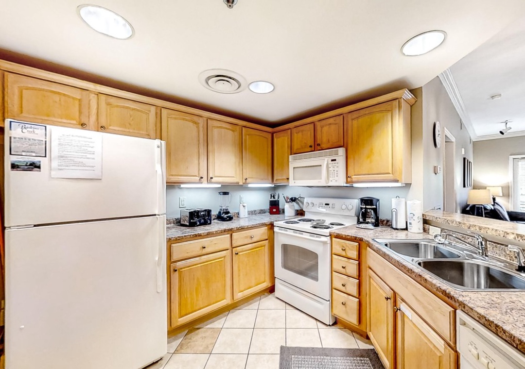 Your fully equipped kitchen features warm wood cabinets, granite counters, and everything you need to prepare meals during your stay.