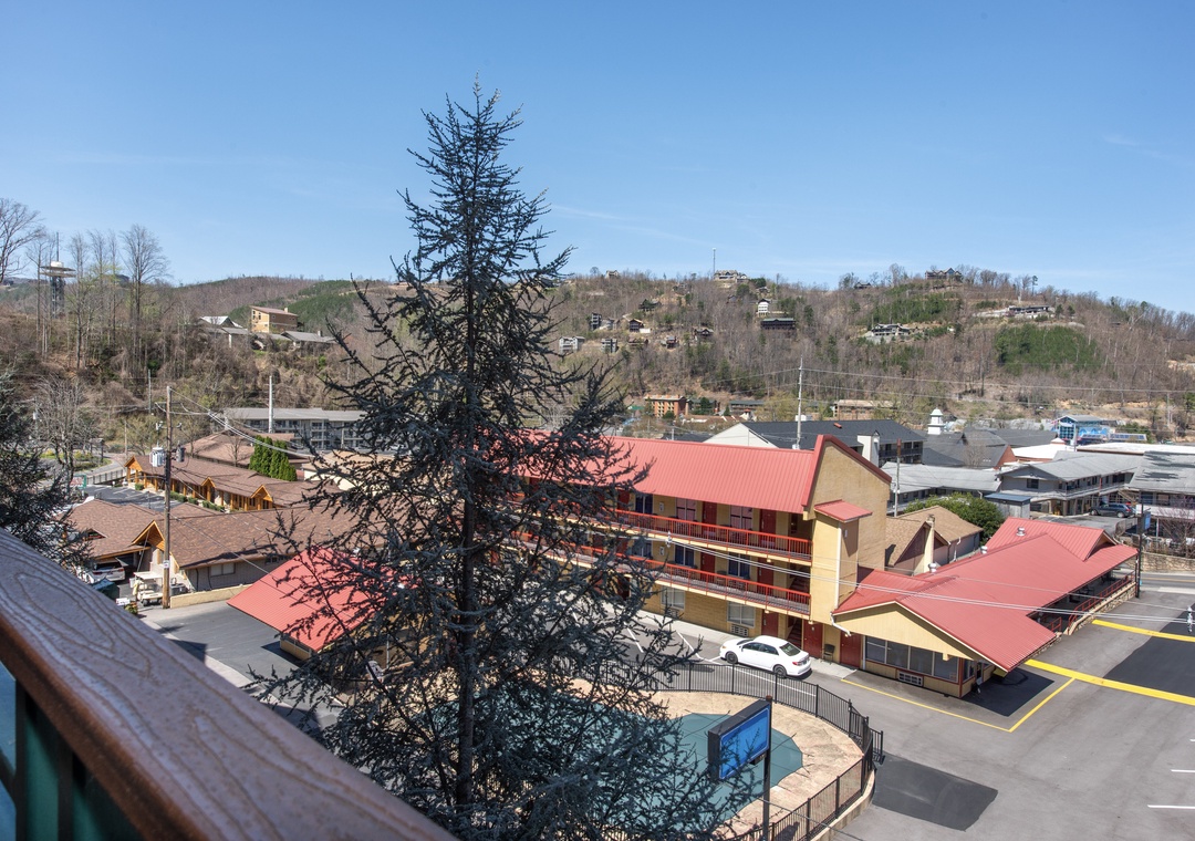 Scenic mountain town view with rolling hills, charming buildings, and peaceful neighborhood atmosphere creates a perfect vacation retreat backdrop.