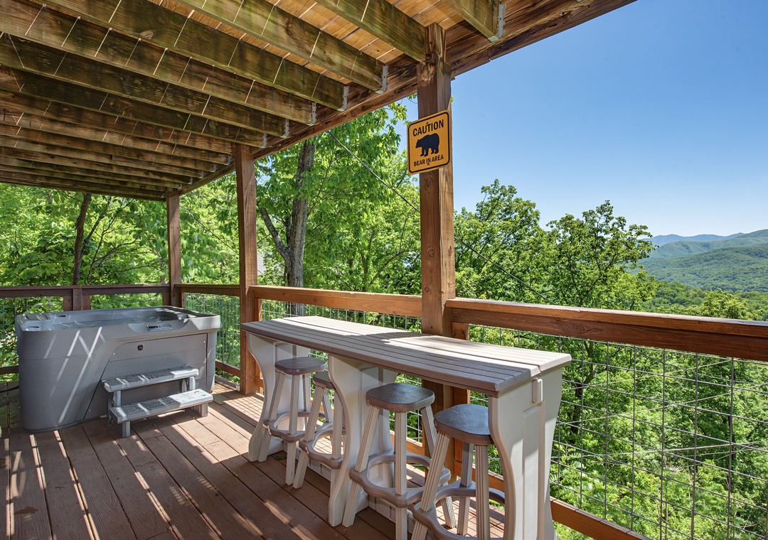 Enjoy morning coffee or evening cocktails at your private outdoor bar with a hot tub, all framed by stunning mountain vistas and forest greenery stretching endlessly before you.