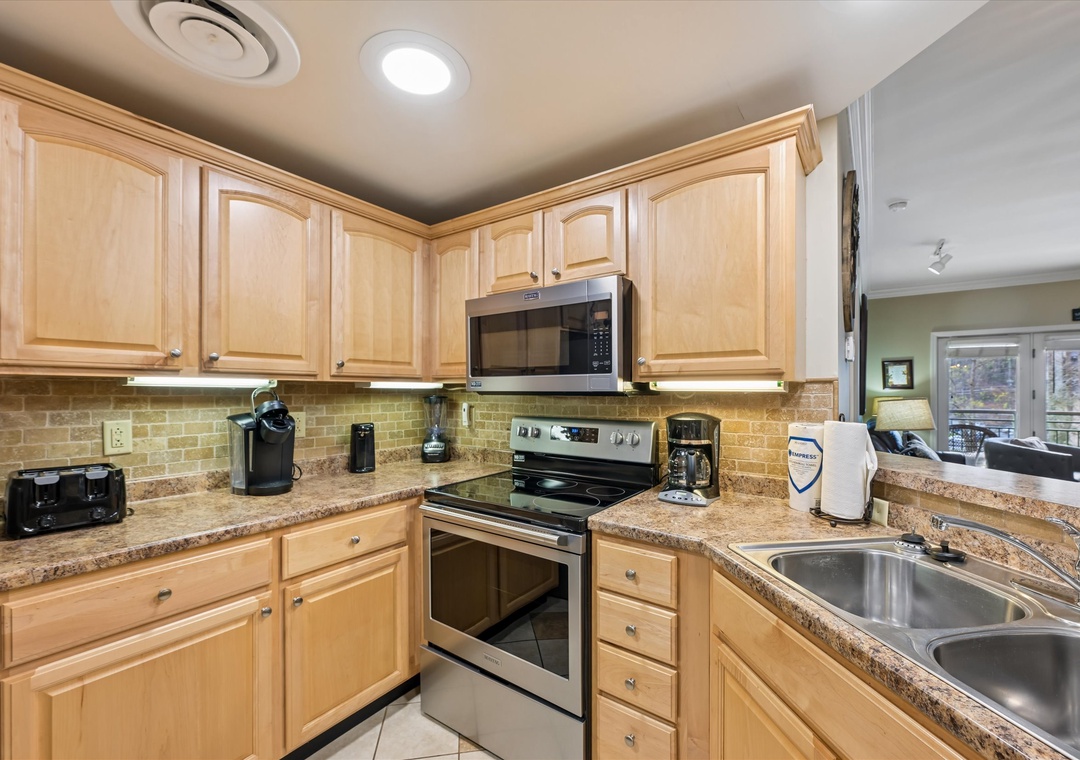 Your fully-equipped kitchen welcomes culinary adventures with granite countertops, warm maple cabinetry, and modern appliances.