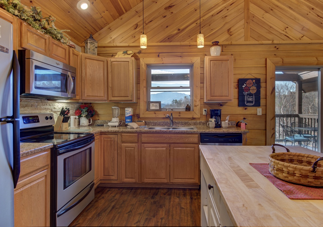 Your fully equipped mountain kitchen invites culinary adventures with granite counters, stainless appliances, and warm wood throughout.