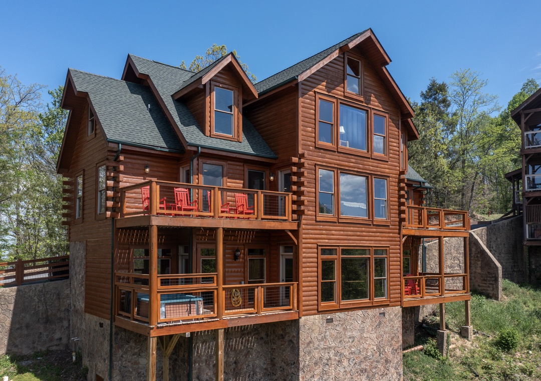 Beautiful log cabin exterior with multiple decks and natural surroundings for a peaceful mountain retreat experience.