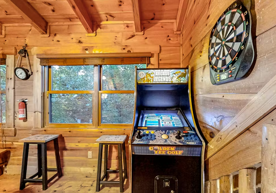 Challenge friends to arcade games and darts in your rustic game room, where classic entertainment meets cozy cabin charm.