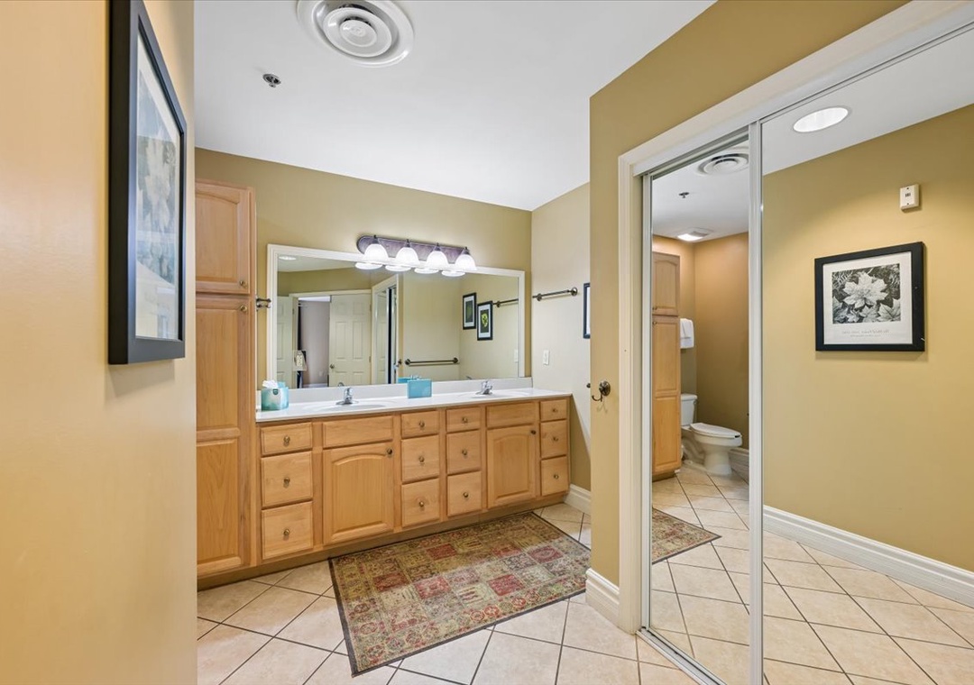 Spacious bathroom with dual sinks and ample storage for all your essentials during your stay.