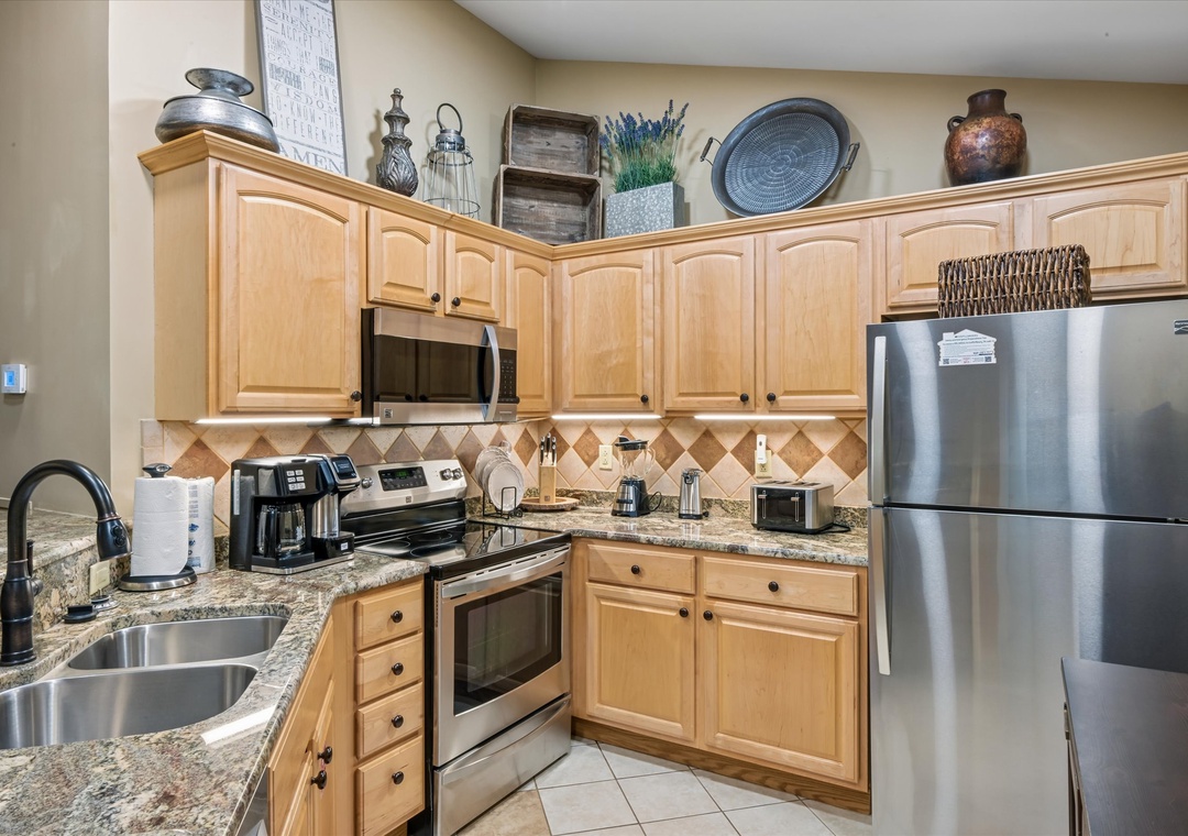 Your fully equipped kitchen awaits with granite counters, stainless steel appliances, and charming decor—perfect for preparing memorable meals together.