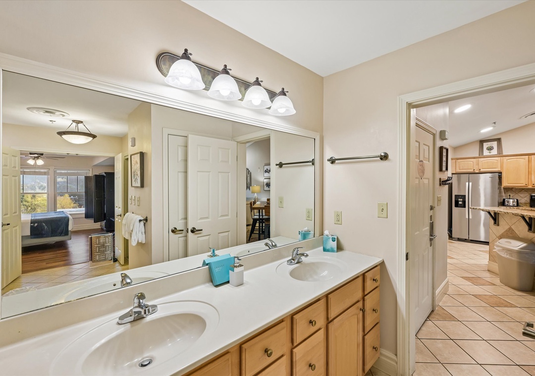 Freshen up in your spacious bathroom with dual vanities and excellent lighting, perfectly positioned between the bedroom and kitchen.