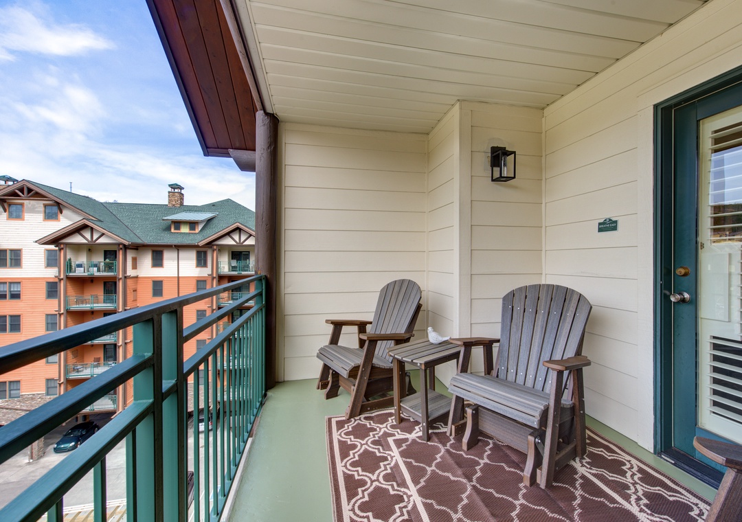 Unwind on your private balcony with comfortable Adirondack chairs, perfect for morning coffee or evening relaxation.