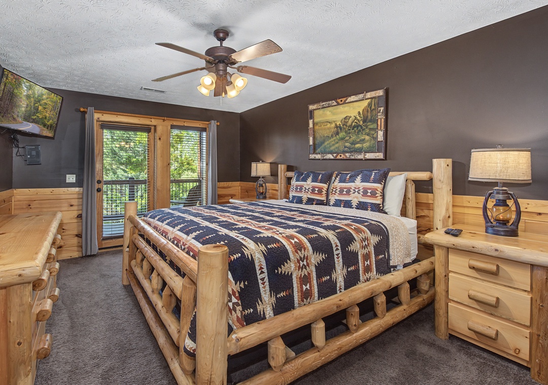 Your cozy cabin bedroom features rustic log furniture and Native American-inspired bedding, creating the perfect mountain retreat atmosphere.