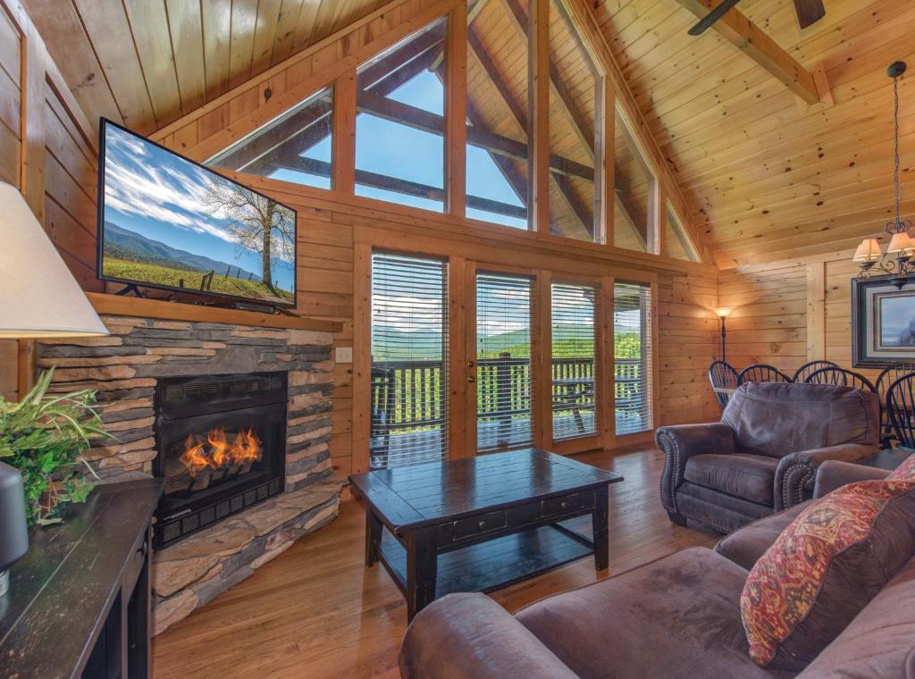 Cozy up by the stone fireplace in this stunning mountain retreat, where vaulted ceilings and panoramic views create your perfect escape.