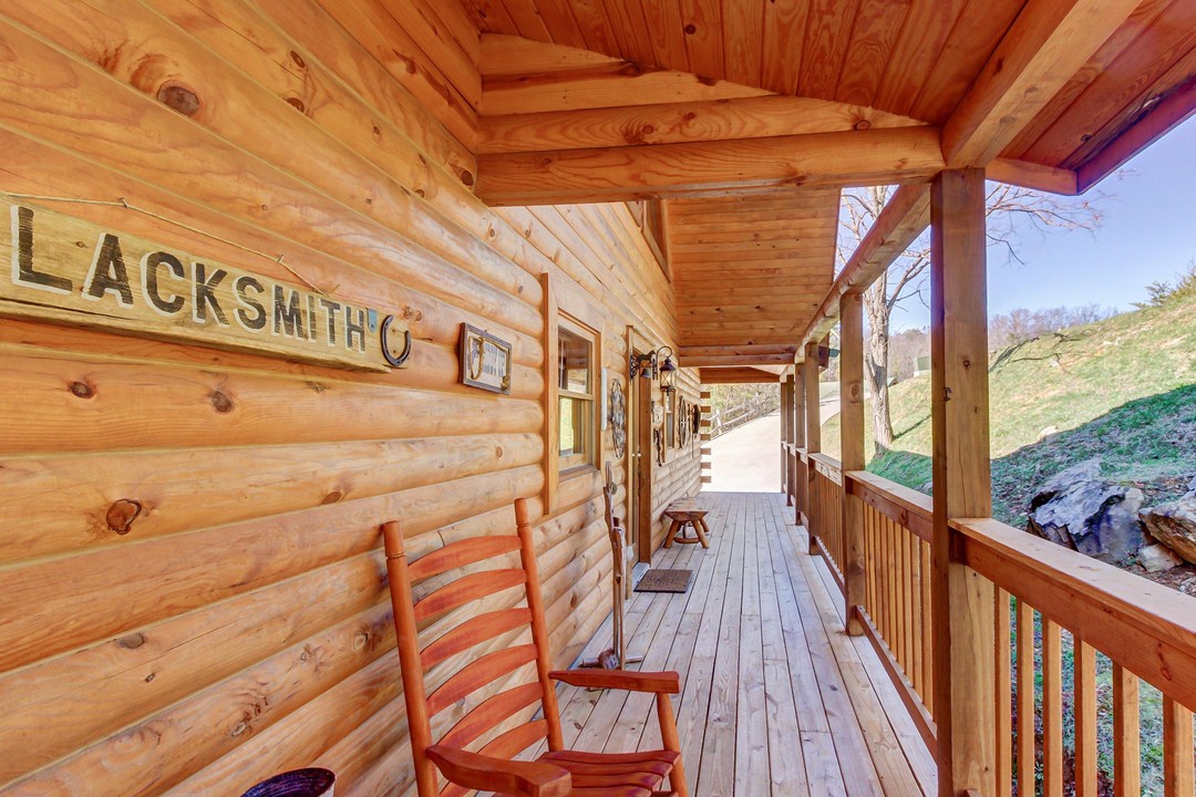 Step onto your private covered porch and settle into a rocking chair, where rustic charm meets peaceful hillside views. This inviting space feels like your own outdoor retreat, perfect for morning coffee or unwinding after a day of adventure.