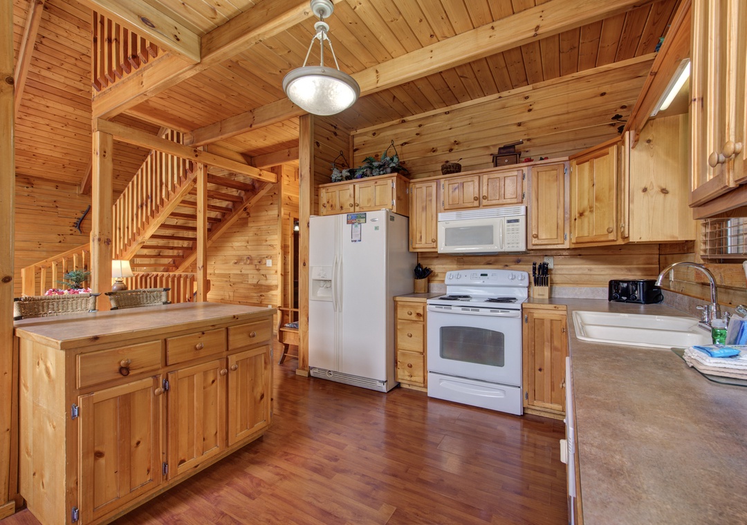 Your rustic kitchen welcomes you with warm wood and modern appliances for memorable mountain meal prep.