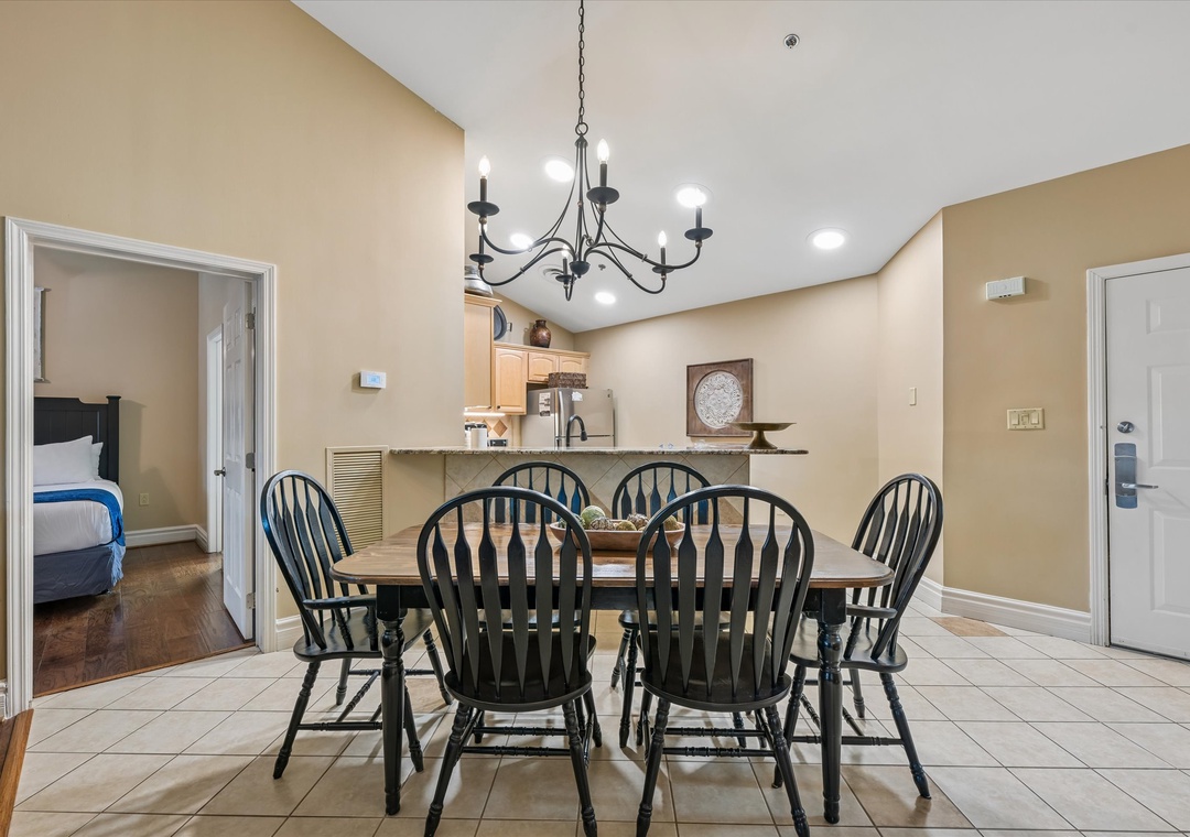 Gather around your elegant dining table for memorable meals with loved ones beneath the warm chandelier glow.