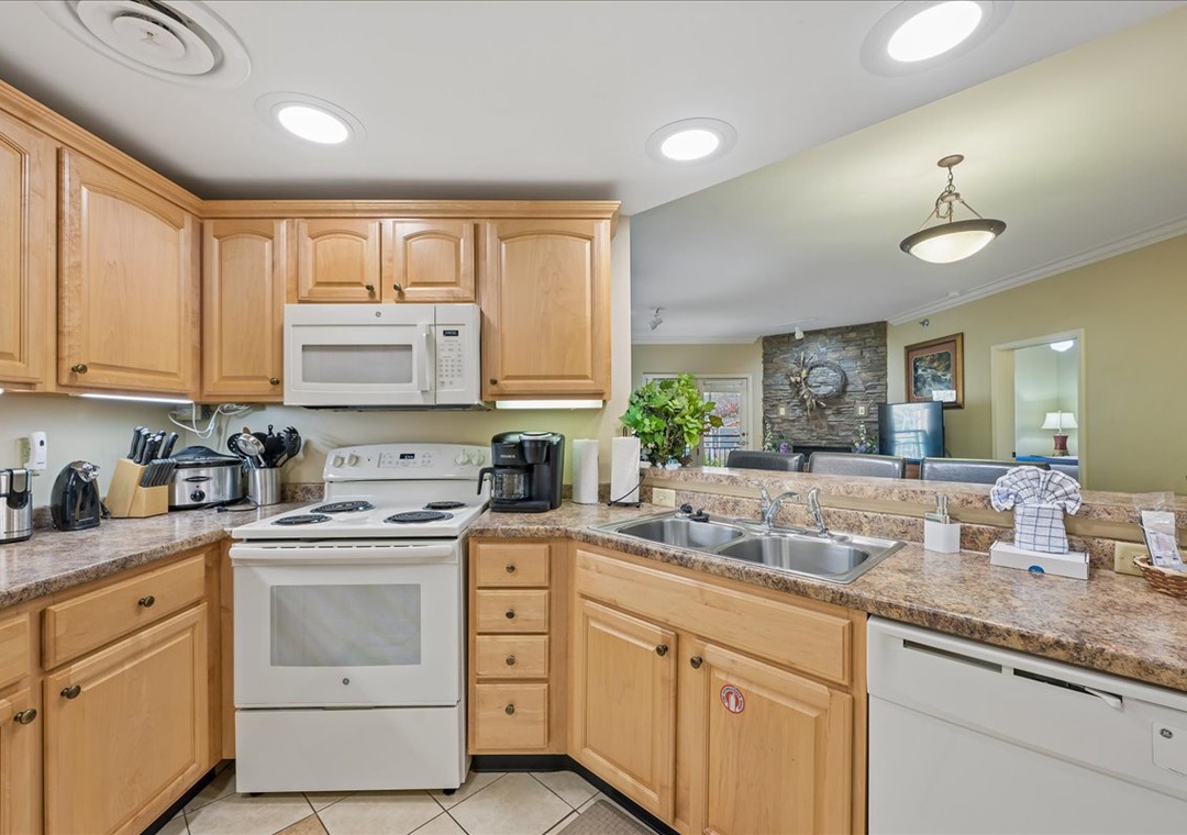 Your fully equipped kitchen features granite counters, warm wood cabinets, and everything needed for home-cooked meals during your stay.