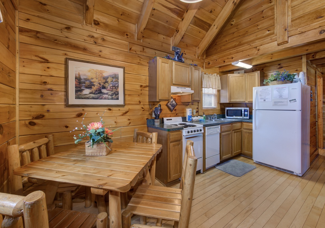 Your rustic cabin kitchen invites cozy meals with warm wood beams overhead and everything needed for home cooking adventures.