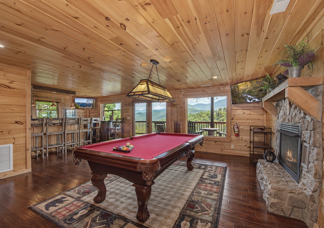 Gather for friendly competition at the pool table, relax by the fireplace, or step outside to your private balcony with stunning mountain views.