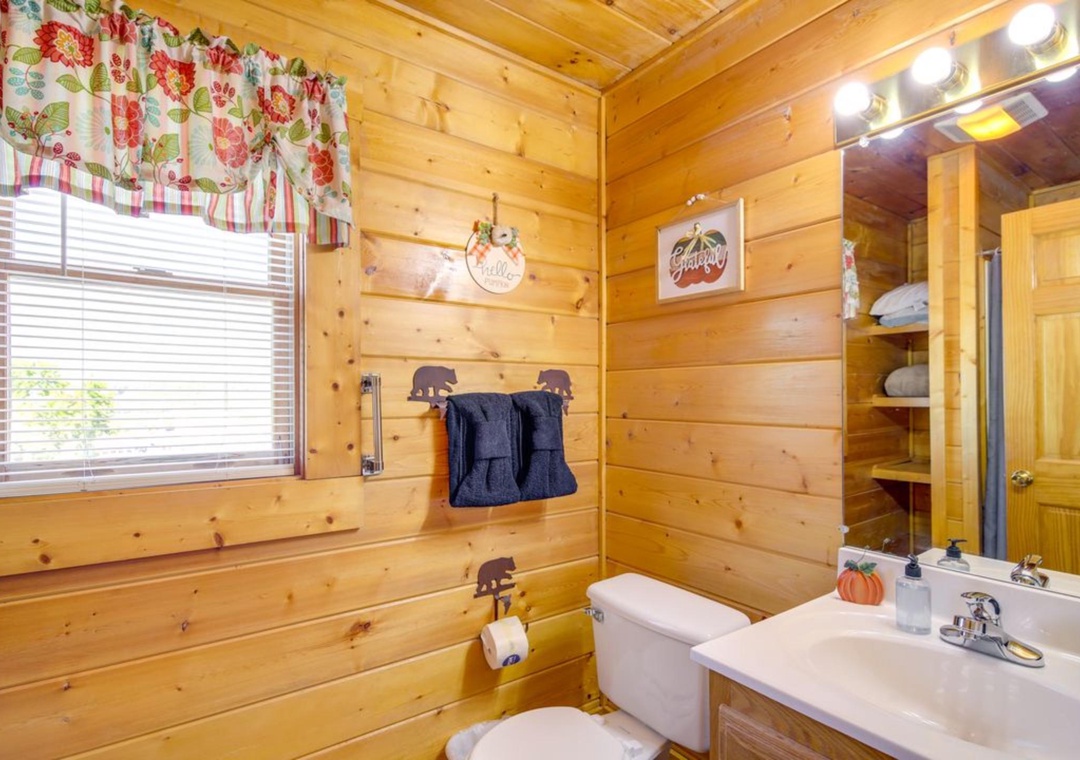 Step into your charming log cabin bathroom with rustic wood walls, cozy touches, and all the comforts you need for a relaxing mountain getaway.