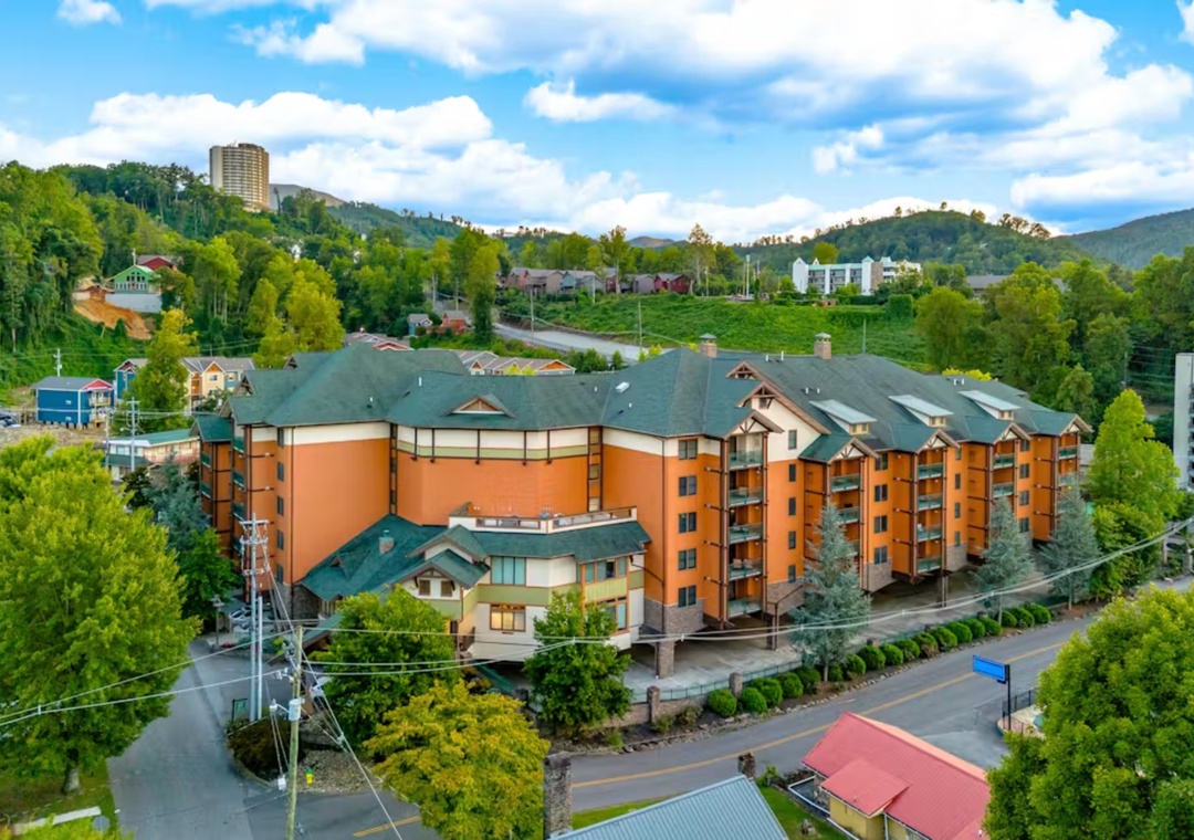 Mountain resort property nestled among lush green hills with scenic valley views and nearby town amenities.