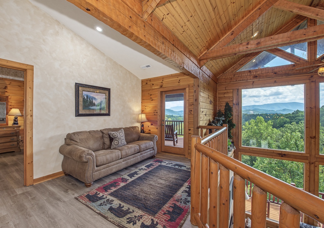 Step into your cozy retreat with soaring cathedral ceilings, warm wood beams, and breathtaking mountain views stretching beyond the floor-to-ceiling windows—your perfect escape awaits.
