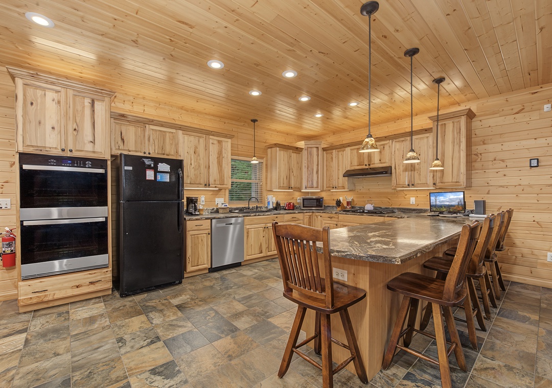 Your gourmet kitchen features granite countertops, stainless appliances, and a spacious island with bar seating—perfect for preparing memorable meals and gathering with loved ones.