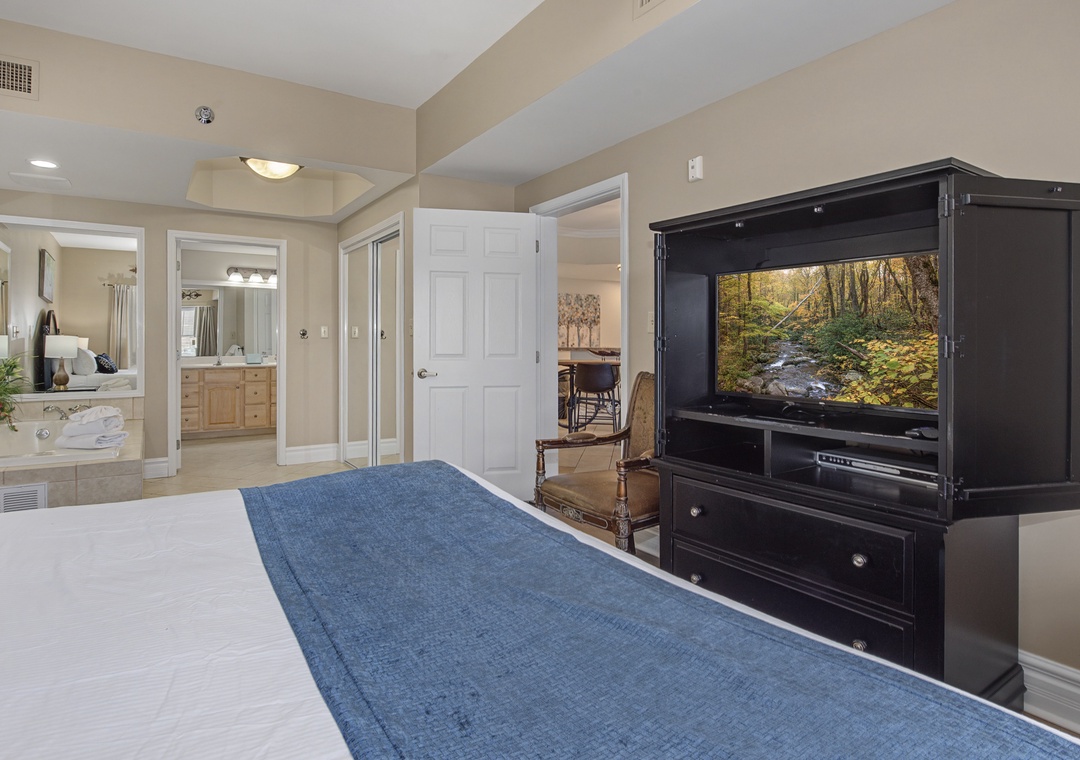 Unwind in your spacious master suite with entertainment center and glimpses of your private ensuite bathroom.