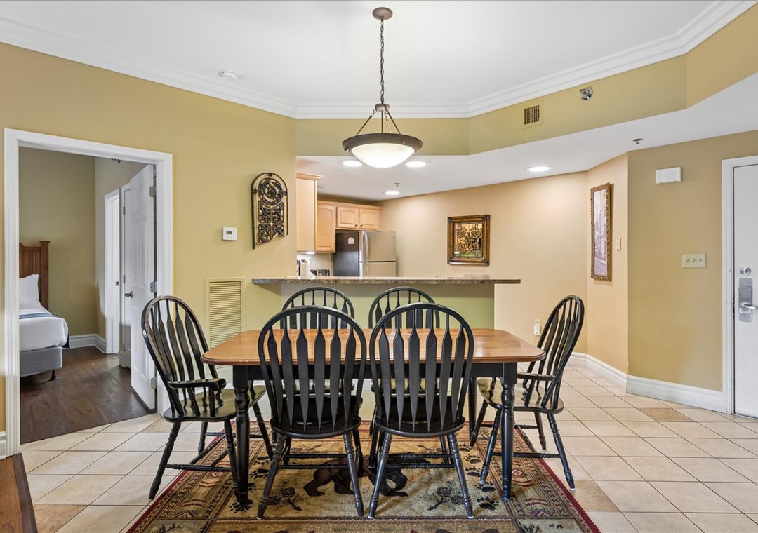 Gather around your spacious dining table for memorable meals with warm lighting and an open kitchen design perfect for entertaining.