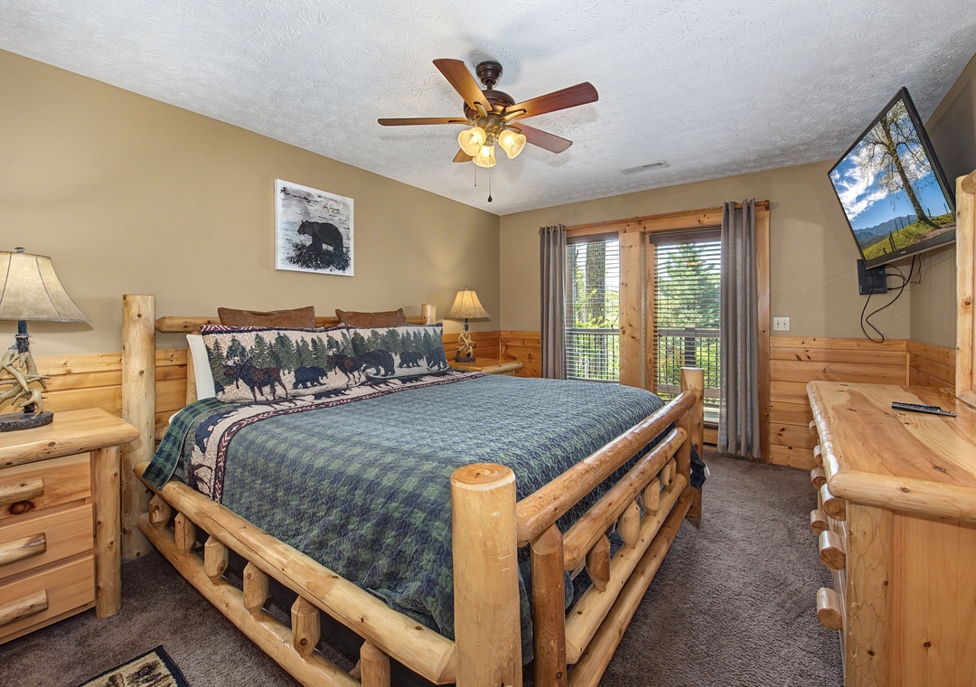Unwind in your rustic log bedroom with cozy pine furnishings and mountain views from your private balcony.