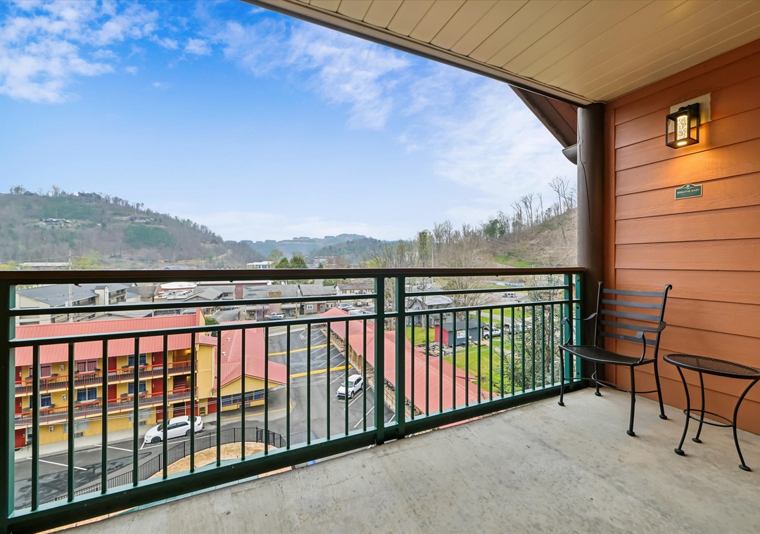 Step onto your private balcony and soak in stunning mountain views while sipping morning coffee at your cozy outdoor table.