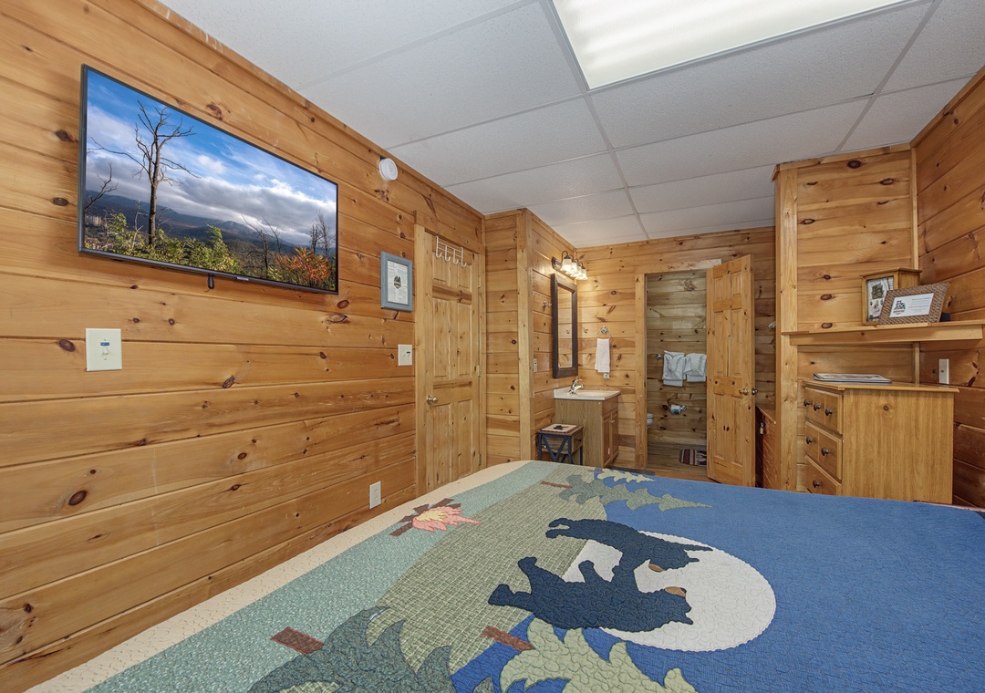 Cozy up in your rustic wood-paneled bedroom with mountain views on the big screen and handcrafted quilted bedding.