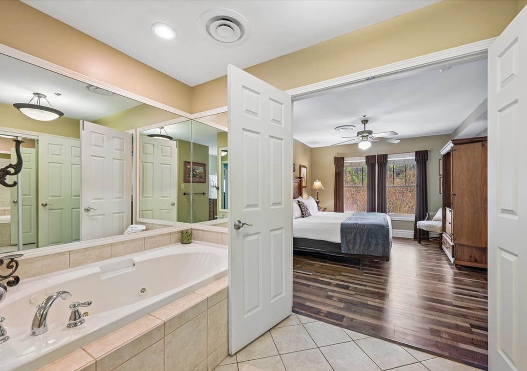 Unwind in your spacious suite with a luxurious jetted tub and elegant bedroom beyond—perfect for relaxing after exploring.
