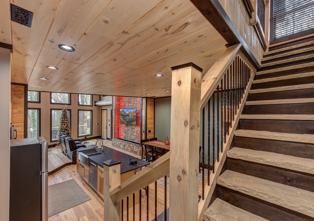 Your rustic-chic retreat features warm wood beams, a sleek kitchen island, and cozy living space where mountain memories begin.