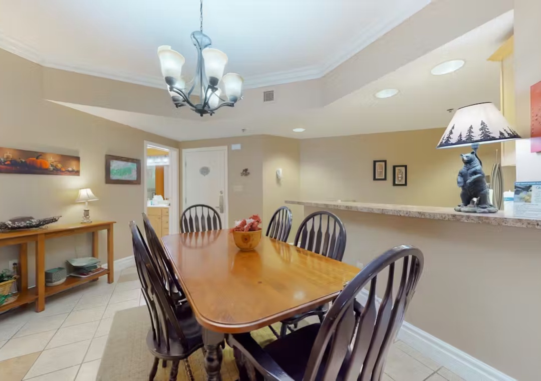 Gather around your spacious dining table for memorable meals together, with cozy lighting and mountain-themed touches creating the perfect atmosphere.