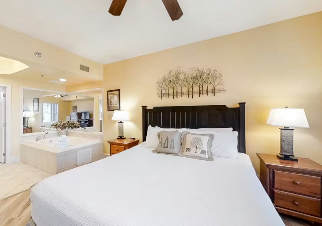 Your spacious suite features a king bed, romantic hot tub, and rustic ceiling beams for the perfect romantic retreat.