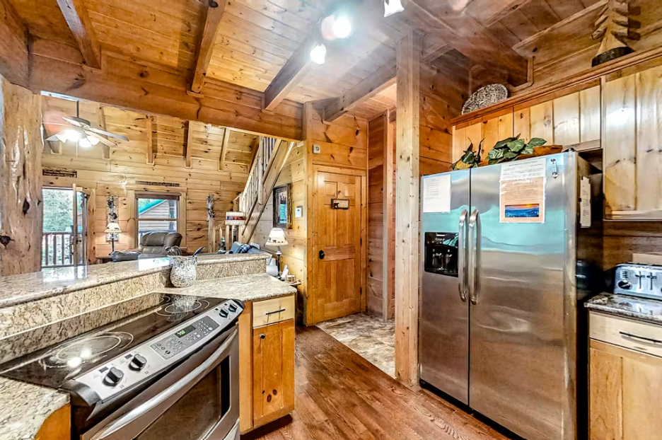 Your rustic cabin kitchen features granite counters, stainless appliances, and warm wood throughout for authentic mountain cooking.