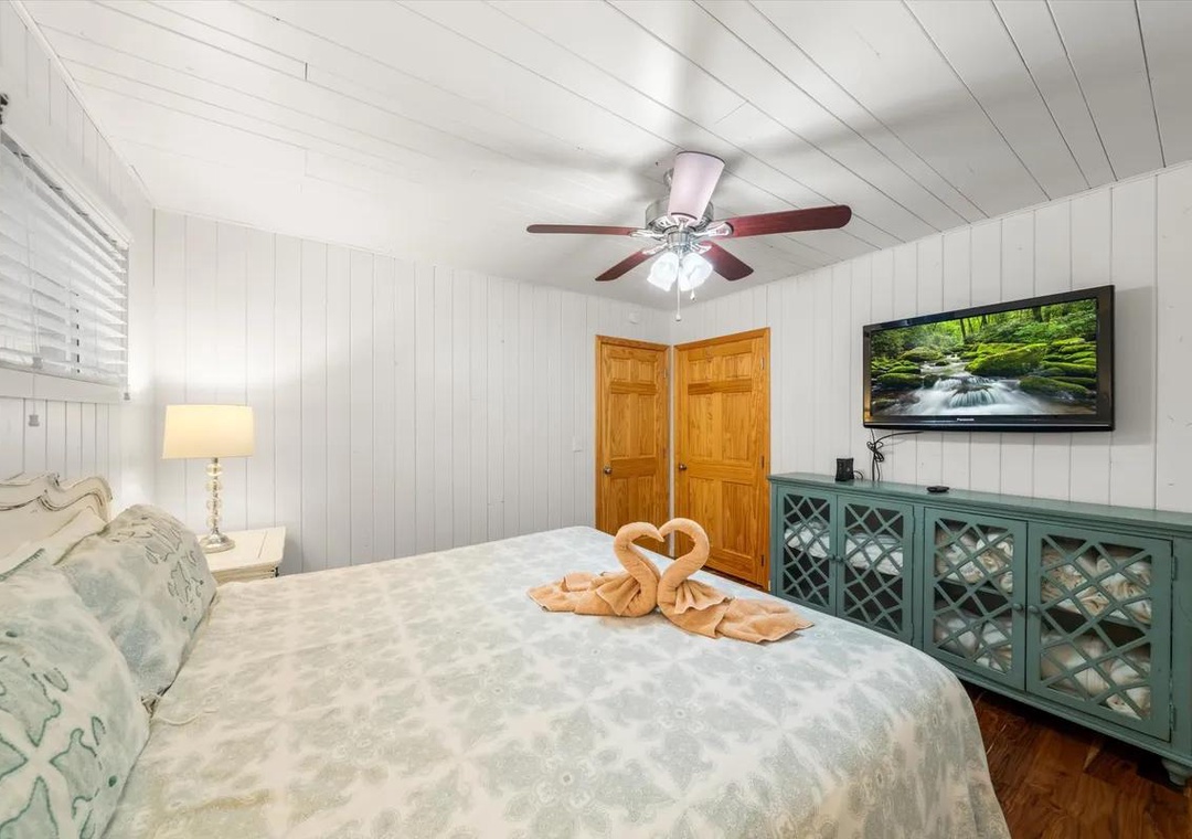 Sink into plush bedding beneath charming white-paneled ceilings, where thoughtful touches like swan-folded towels and coastal accents make your retreat feel special and serene.